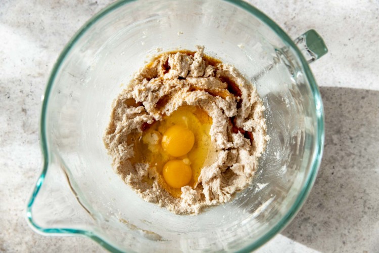 dry ingredients and two eggs in a clear bowl