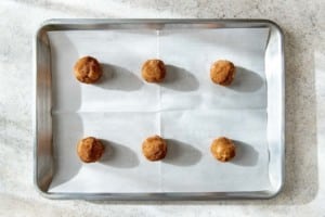 snickerdoodle cookie dough balls on a baking sheet
