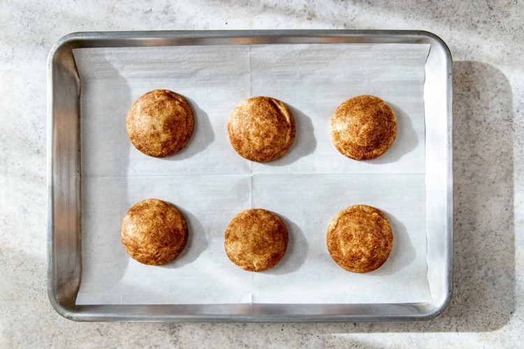 snickerdoodle cookie dough balls on a baking sheet