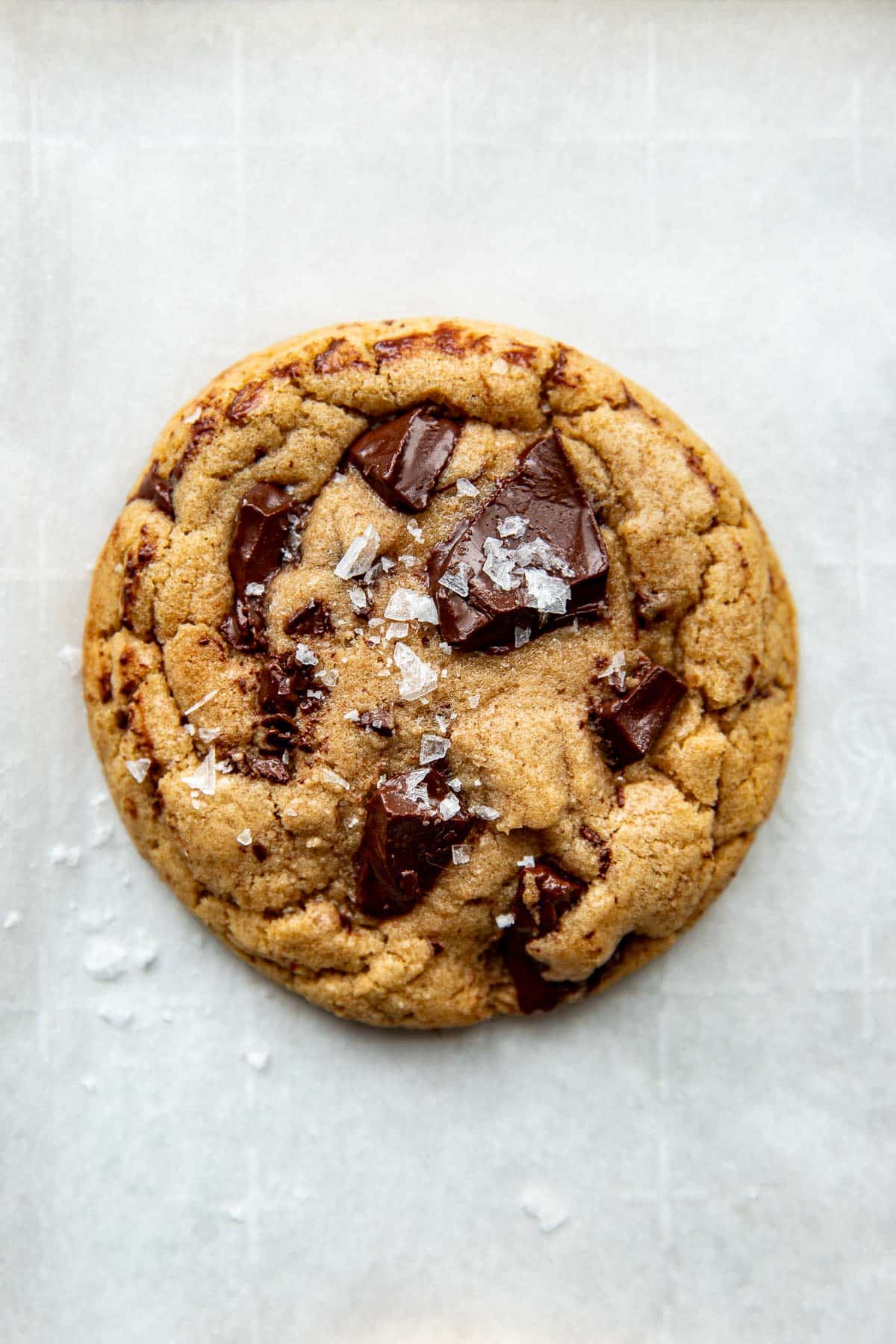 a freshly baked cookie with chocolate chunks and flaky sea salt on top. 