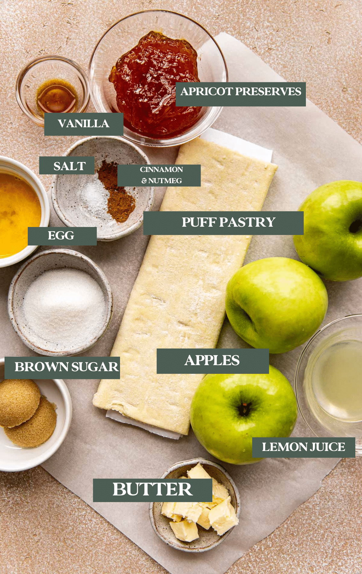 ingredients needed to make a puff pastry apple tart on parchment paper. 