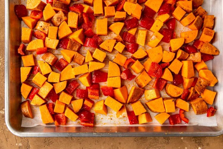 roasted sweet potatoes and bell peppers on a sheet pan.