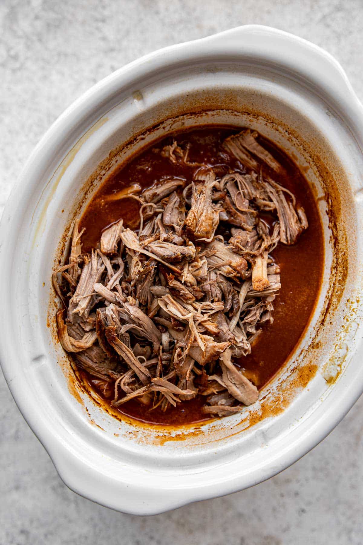 pulled pork added to a slow cooker in the sauce. 