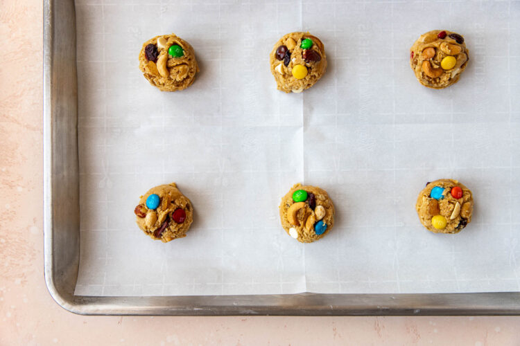 scooped cookies on a parchment paper lined baking sheet.