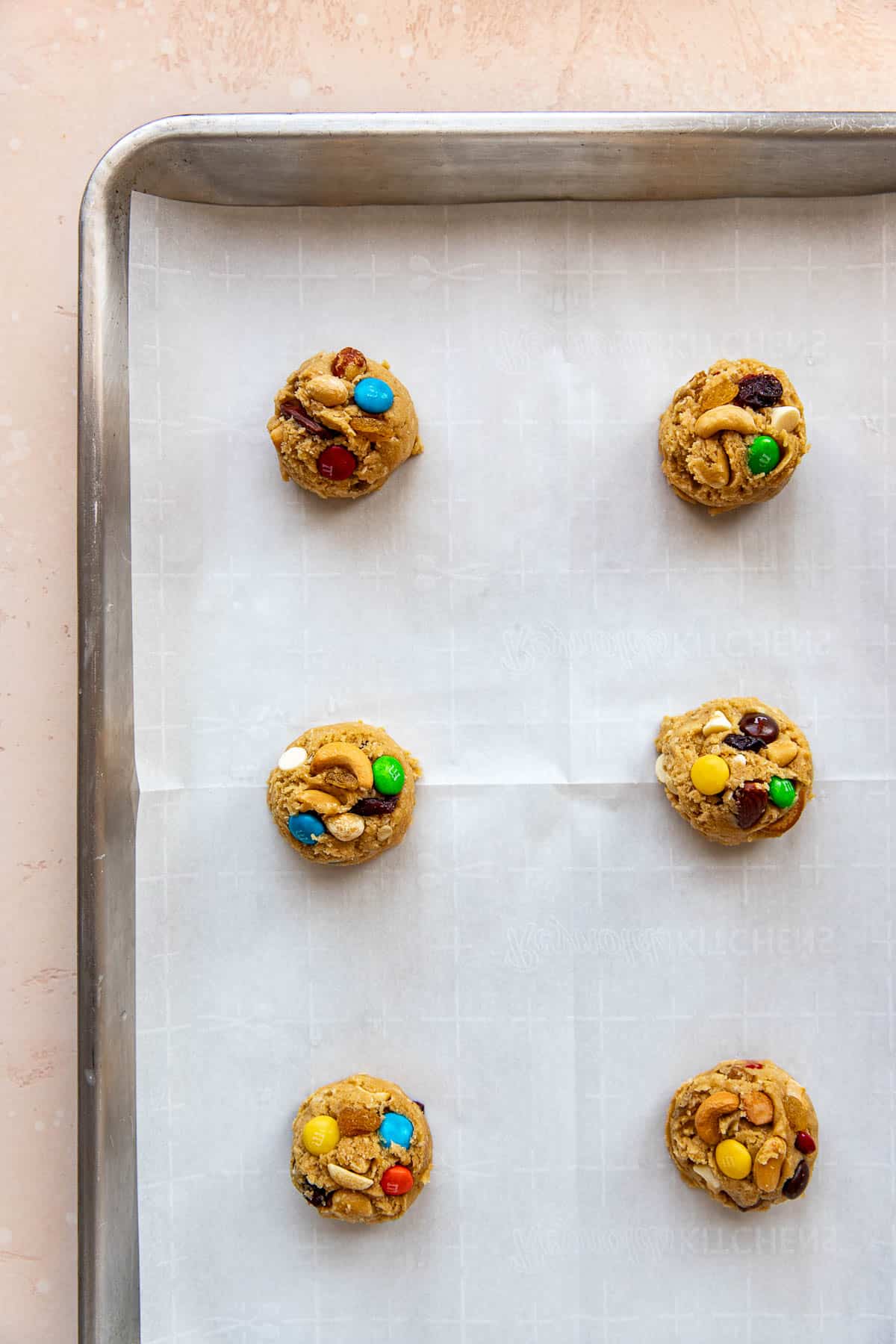 trail mix cookies on a baking sheet lined with parchment paper. 