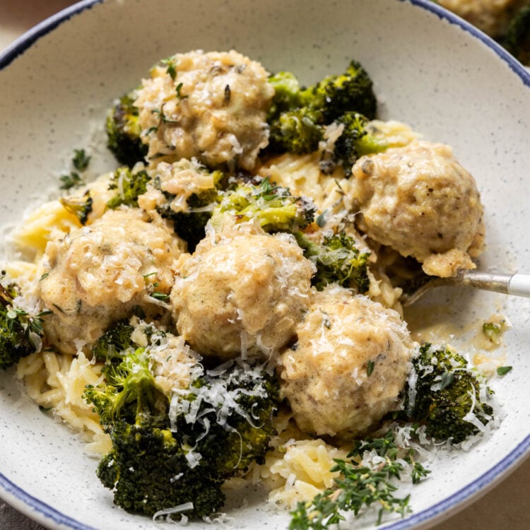 Chicken meatballs with broccoli and orzo in a bowl.