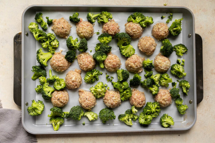 chicken meatballs and broccoli on a sheet pan.