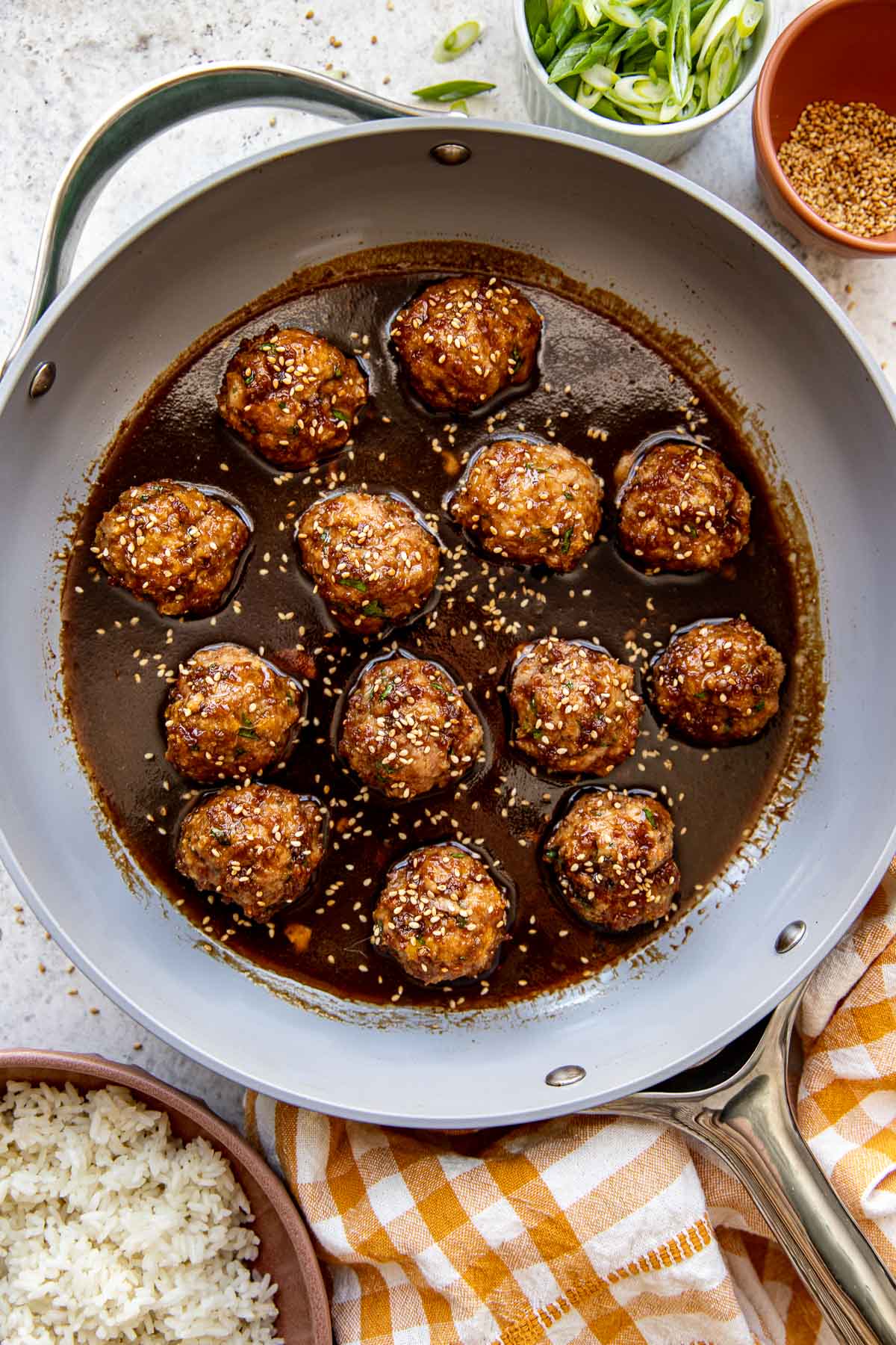 meatballs in a skillet with a sauce over the top. 