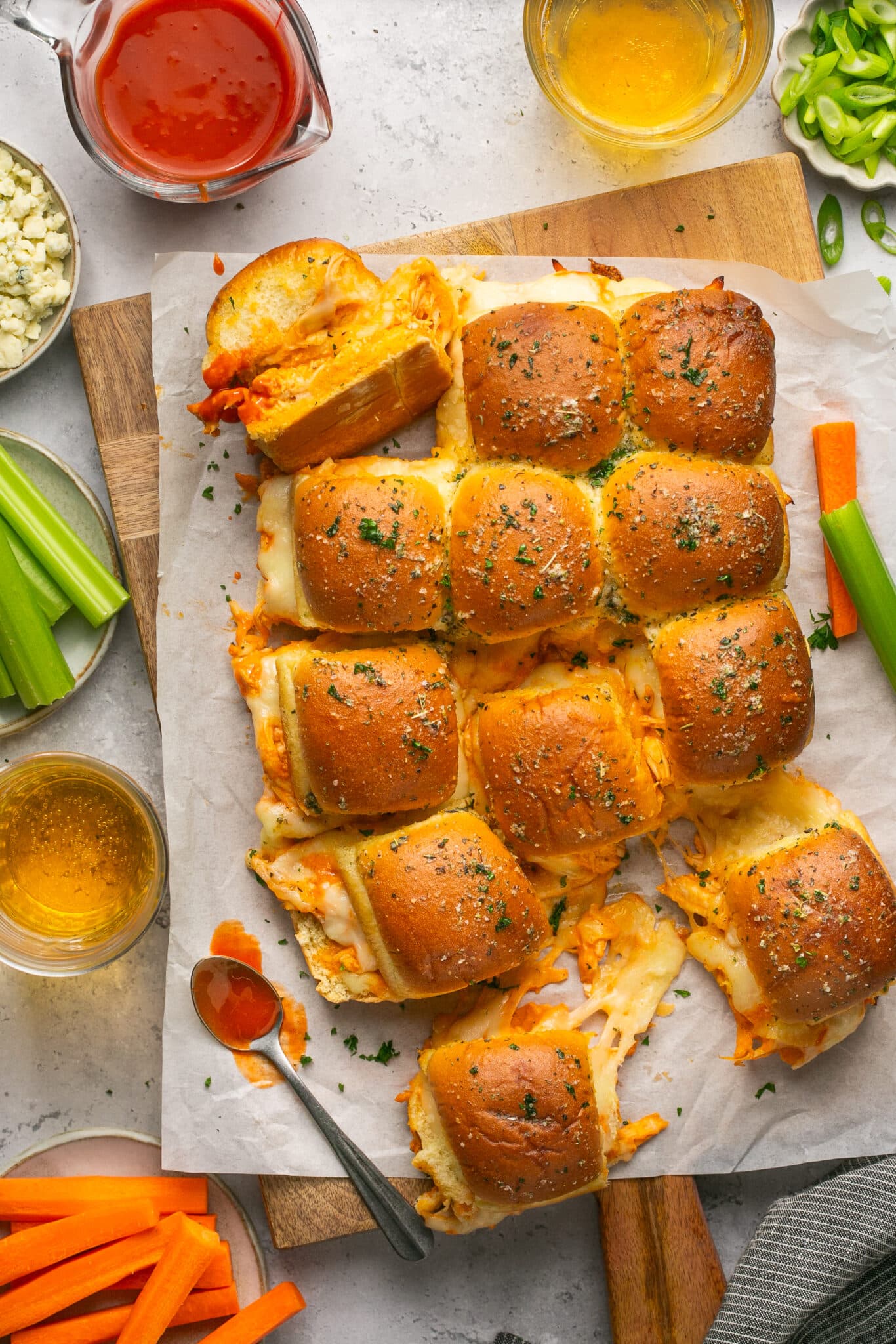 buffalo sliders made with chicken on a cutting board. 
