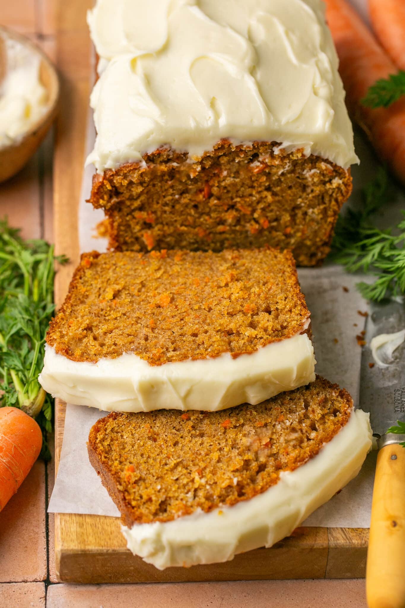 sliced carrot cake bread on a cutting board. 