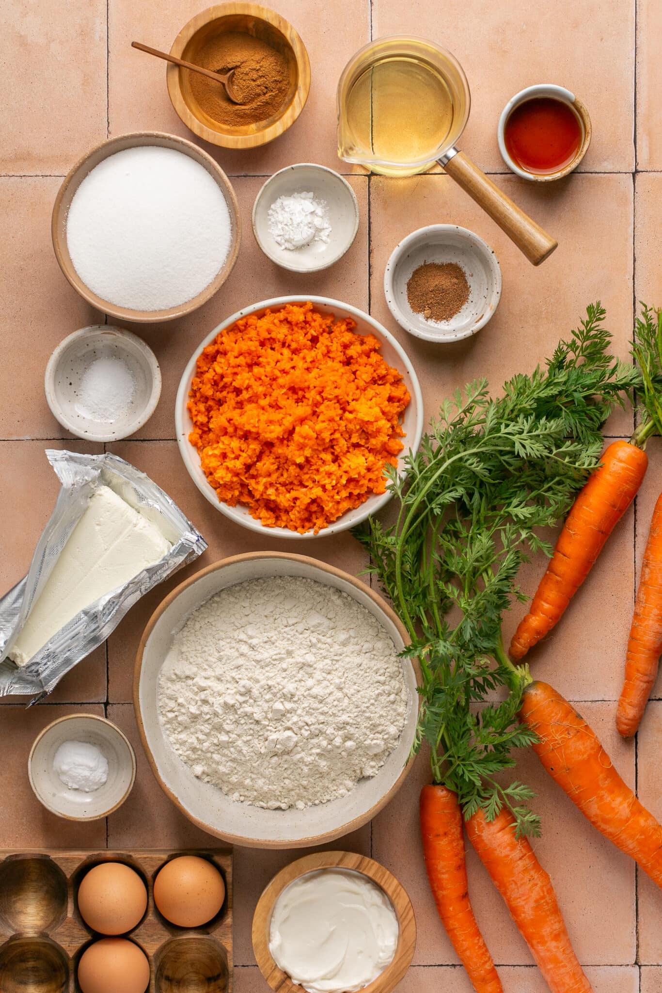 ingredients in small dishes needed to make a carrot cake bread. 