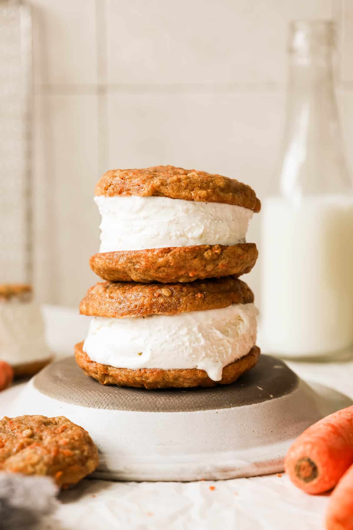 two ice cream sandwiches stacked on a plate.