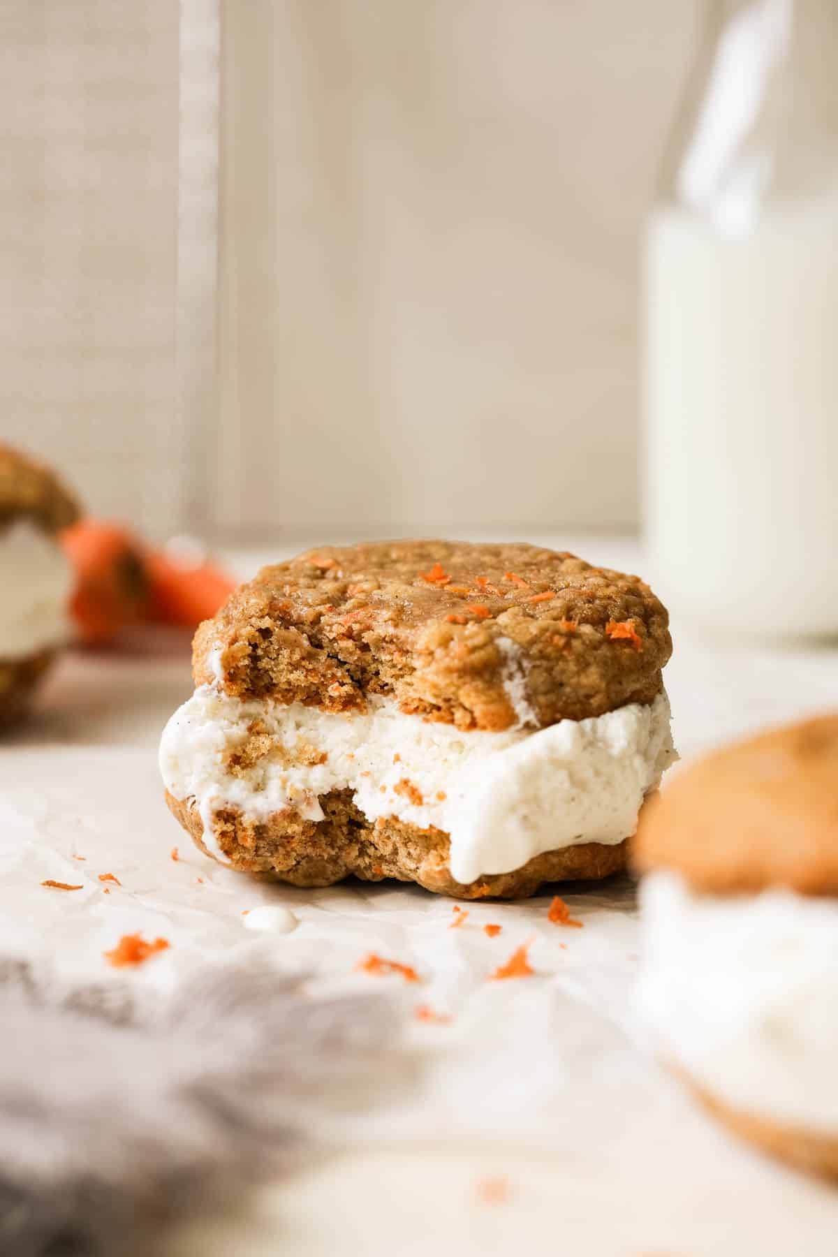 a bite taken out of a carrot cake cookie ice cream sandwich. 