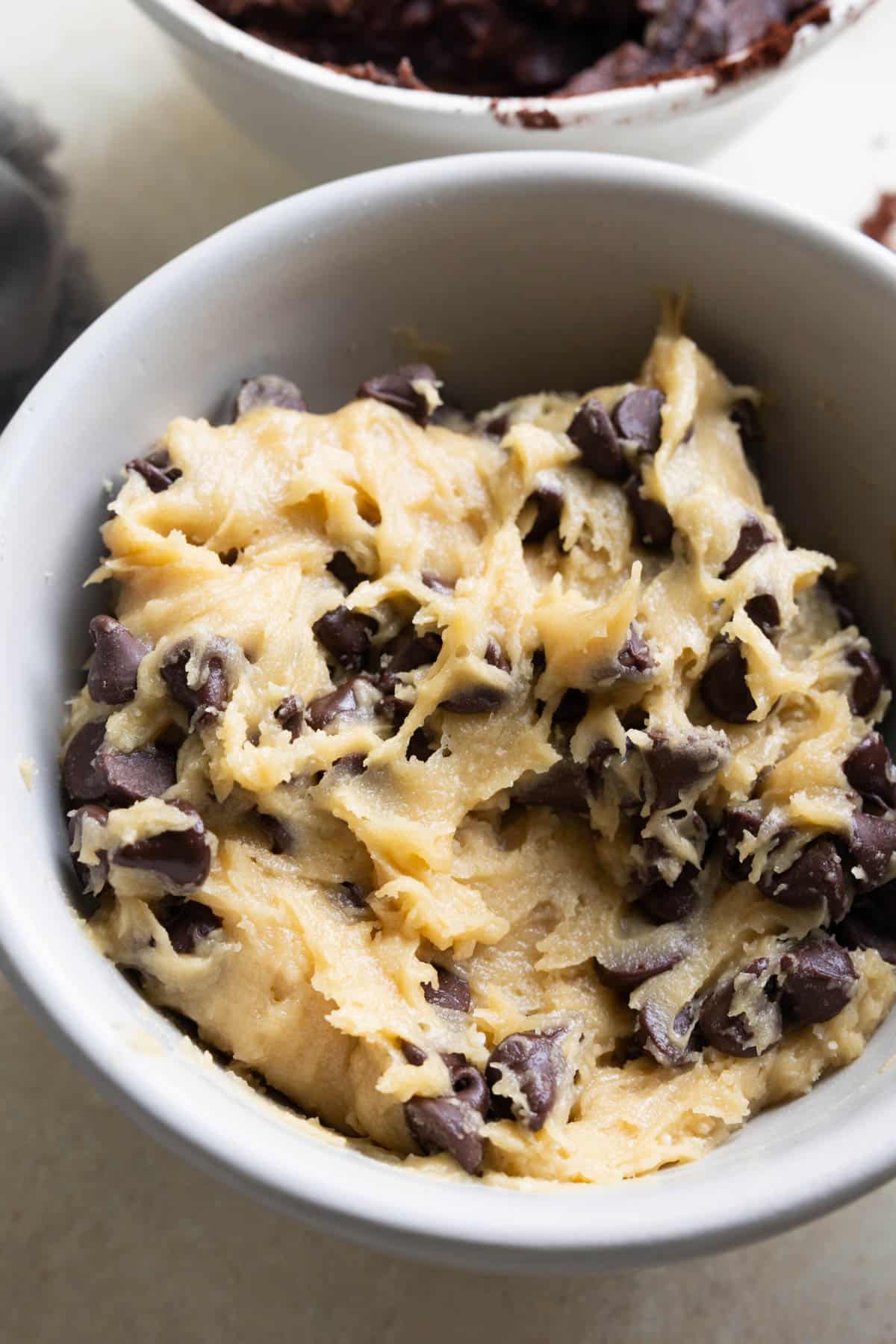 chocolate chip cookie dough in a grey bowl.