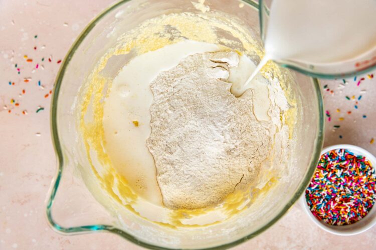 dry ingredients in a glass mixing bowl with milk poured in.