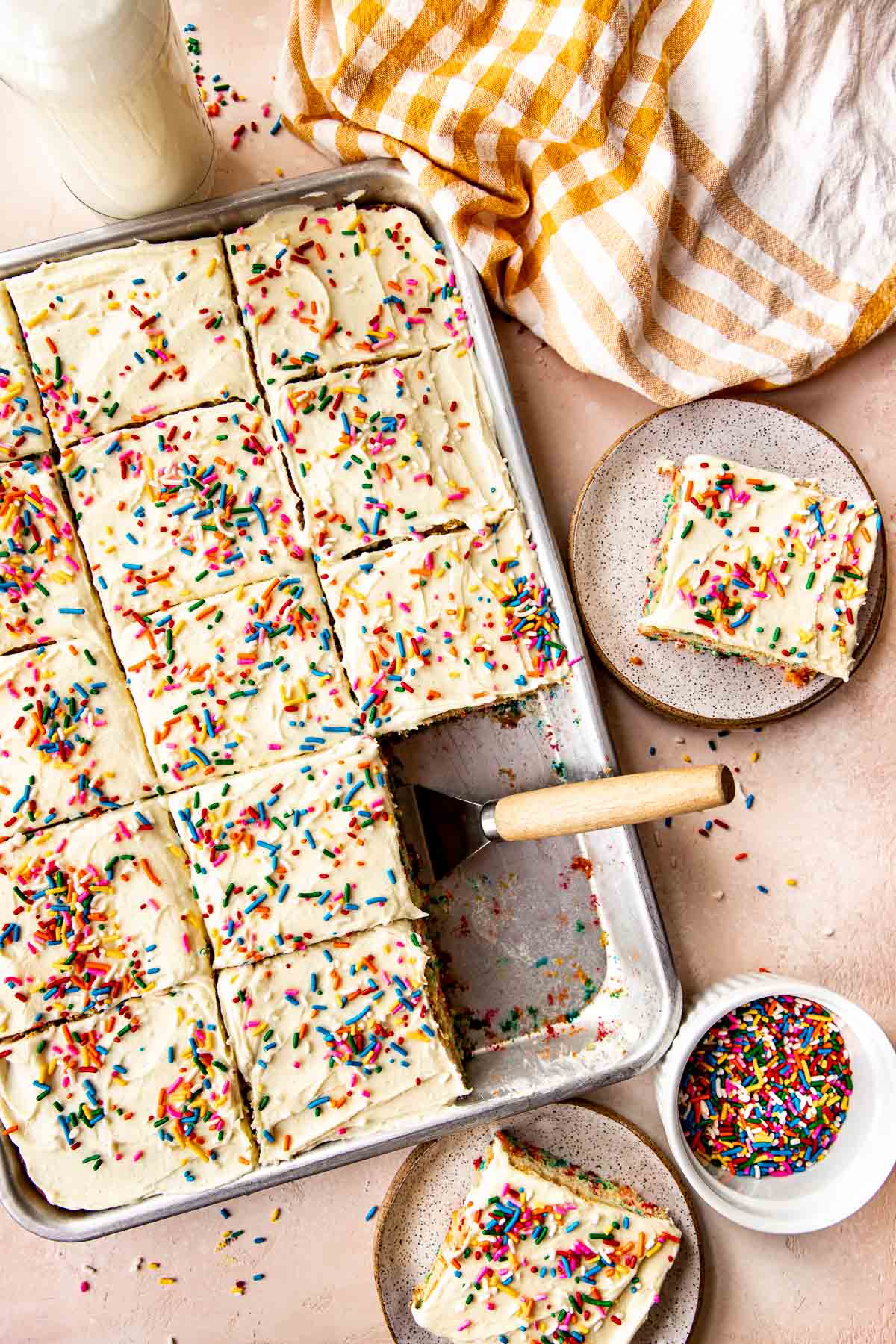 funfetti sheet cake being served onto plates. 
