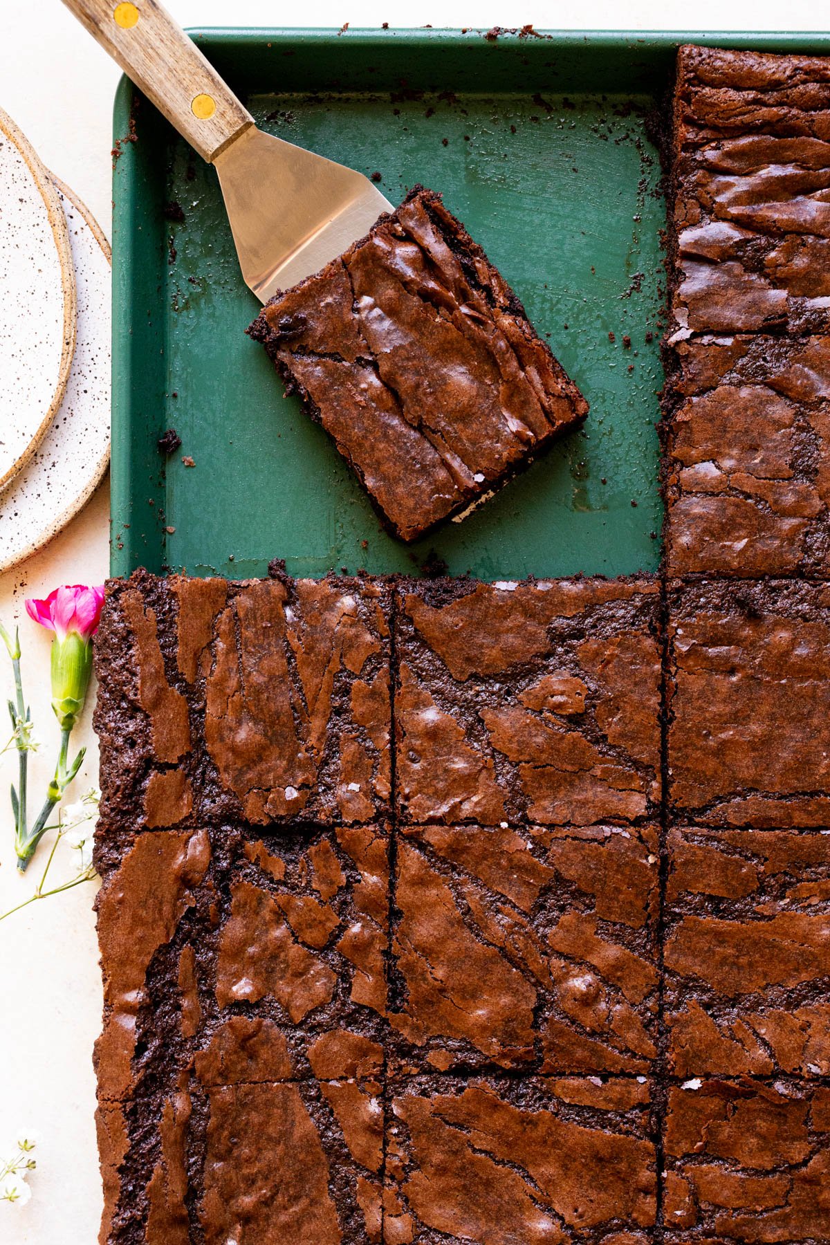 brownies on a green sheet pan cut into squares. 