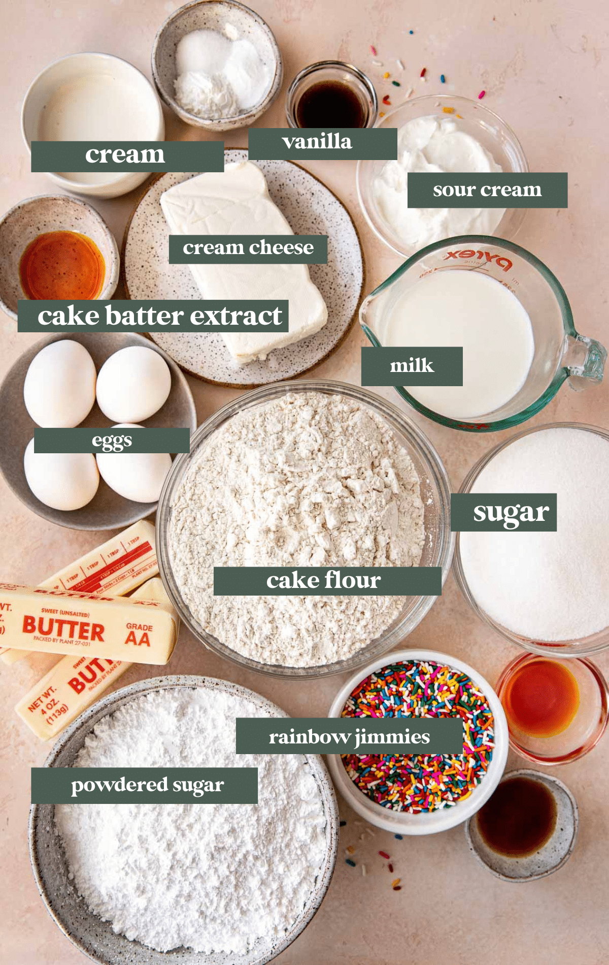 ingredients to make a funfetti cake in class bowls and measuring cups. 