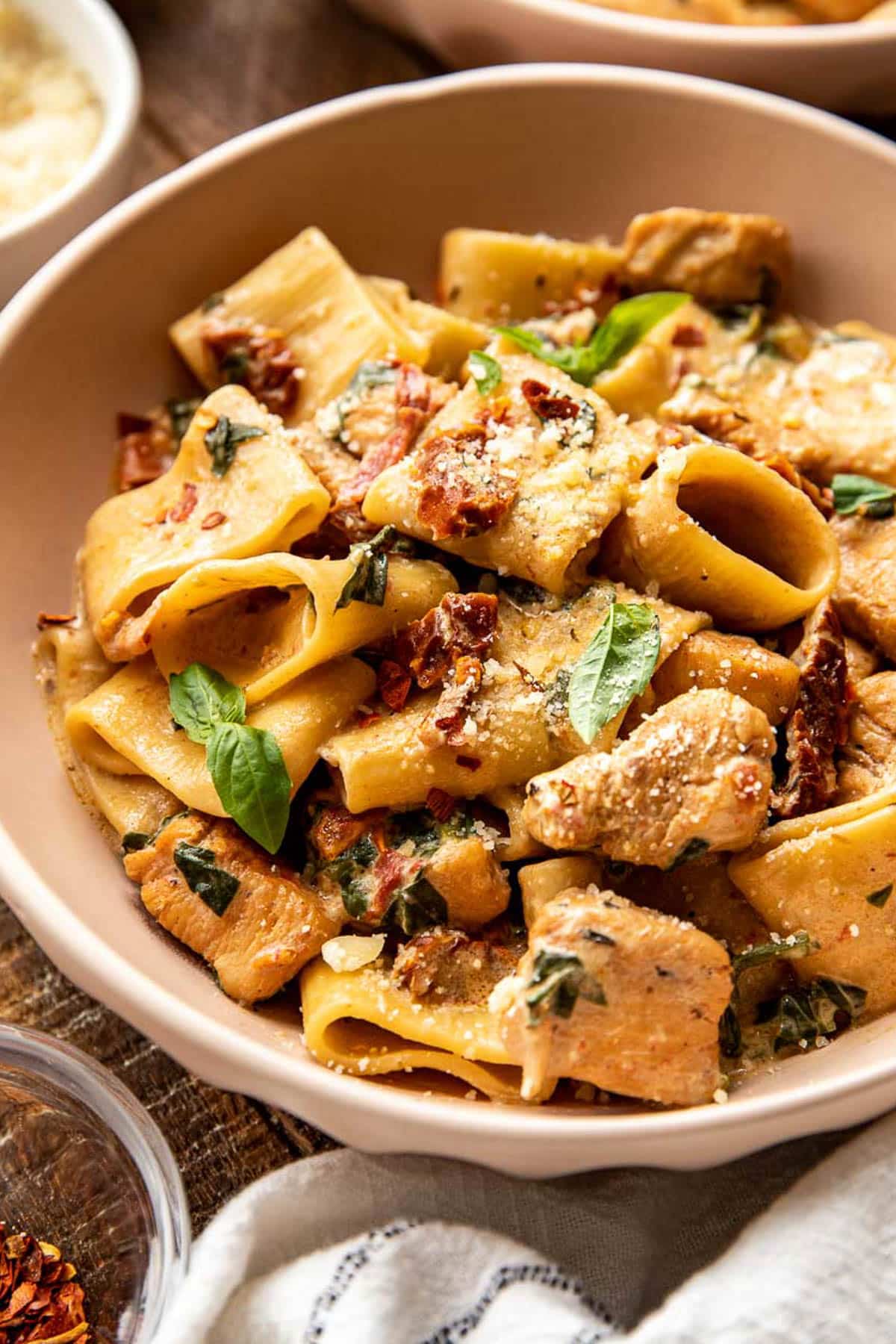 an up close image of chicken and pasta in a bowl. 