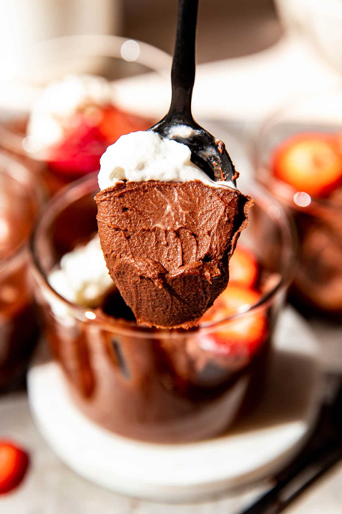 a spoon with chocolate mousse on it.