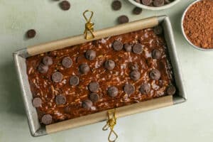 double chocolate zucchini bread batter in an aluminum loaf pan.