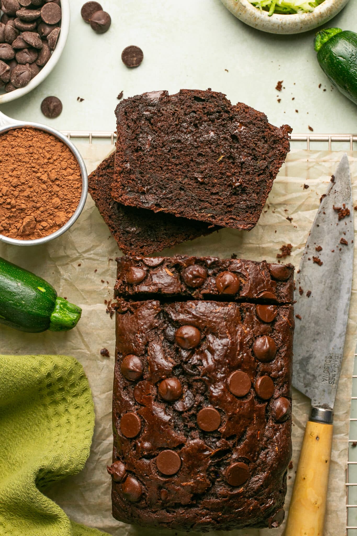 chocolate zucchini bread sliced on parchment paper. 