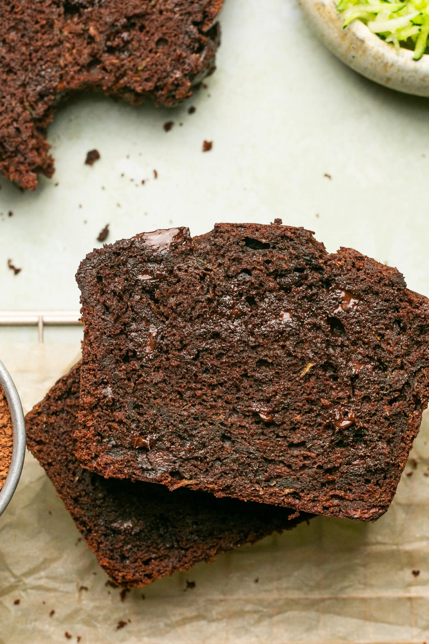 a slice of freshly baked double chocolate zucchini bread on parchment paper. 