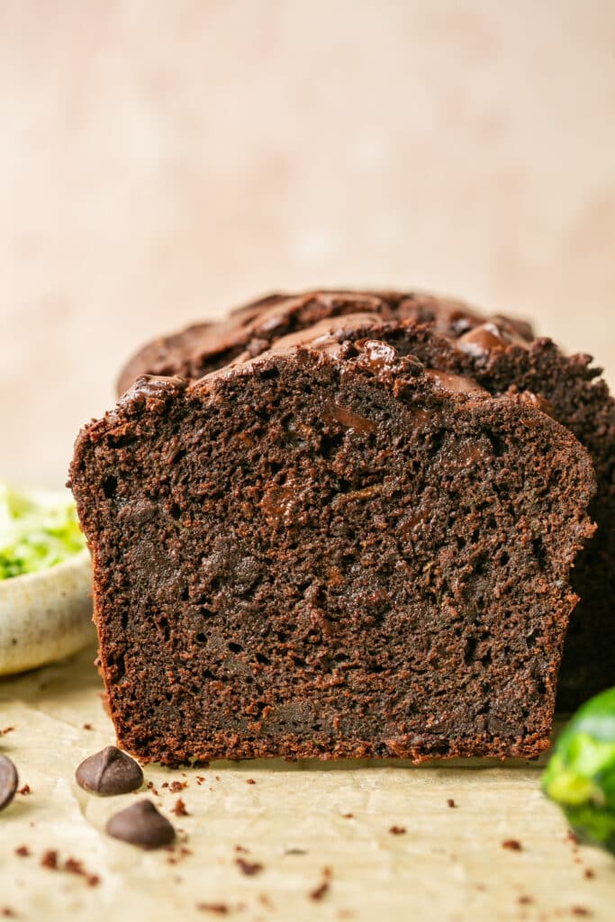 a slice of freshly baked double chocolate zucchini bread on parchment paper. 