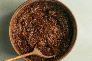 double chocolate zucchini bread batter in a wooden bowl.