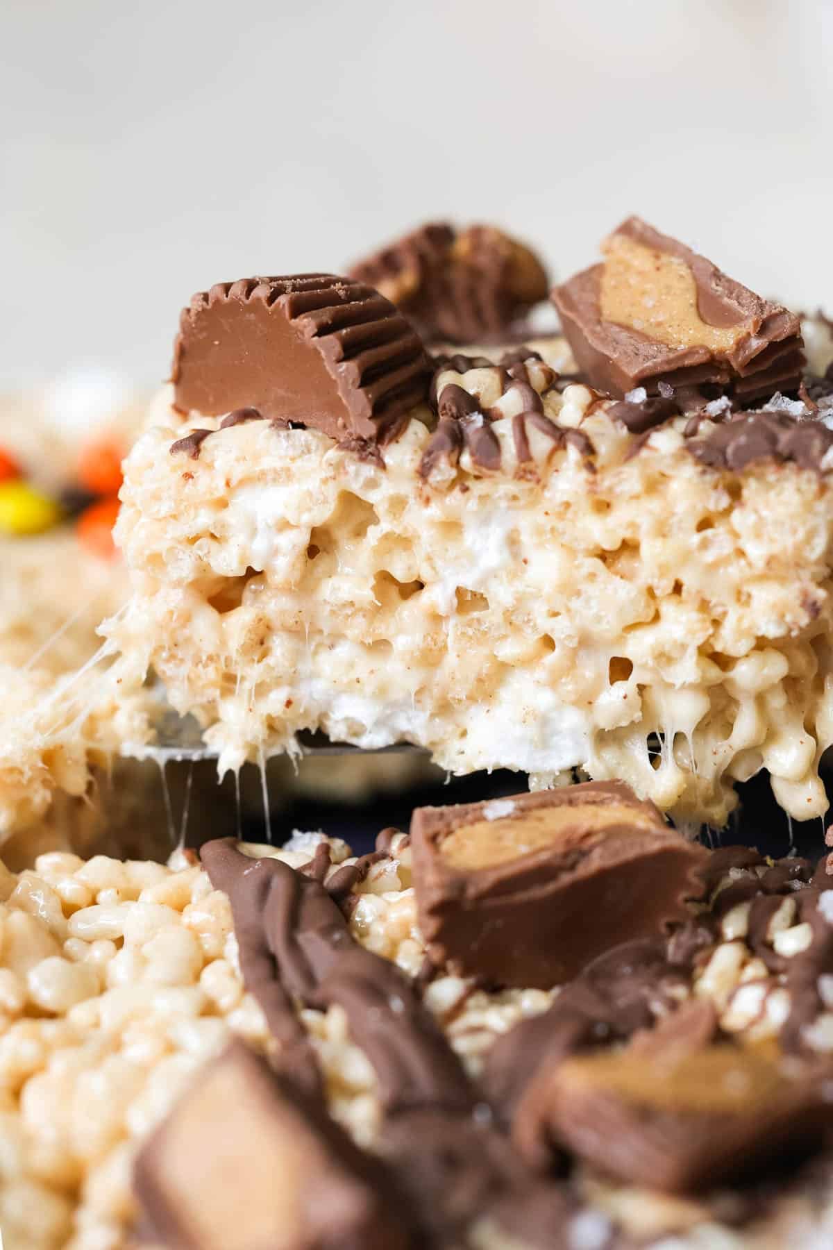 a close up image of a rice krispie with peanut butter cups on top. 