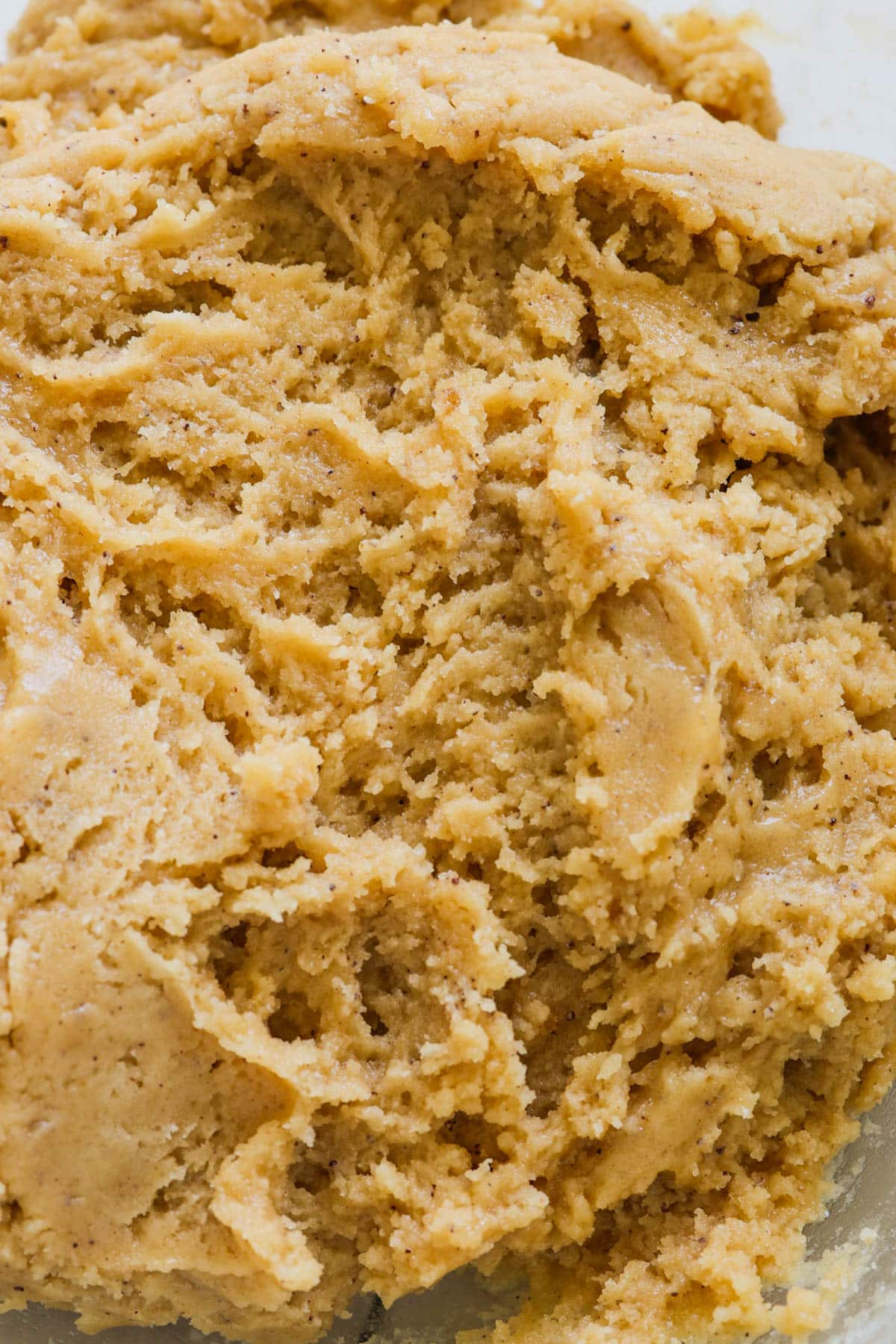 a close up image of brown butter snickerdoodle cookie dough