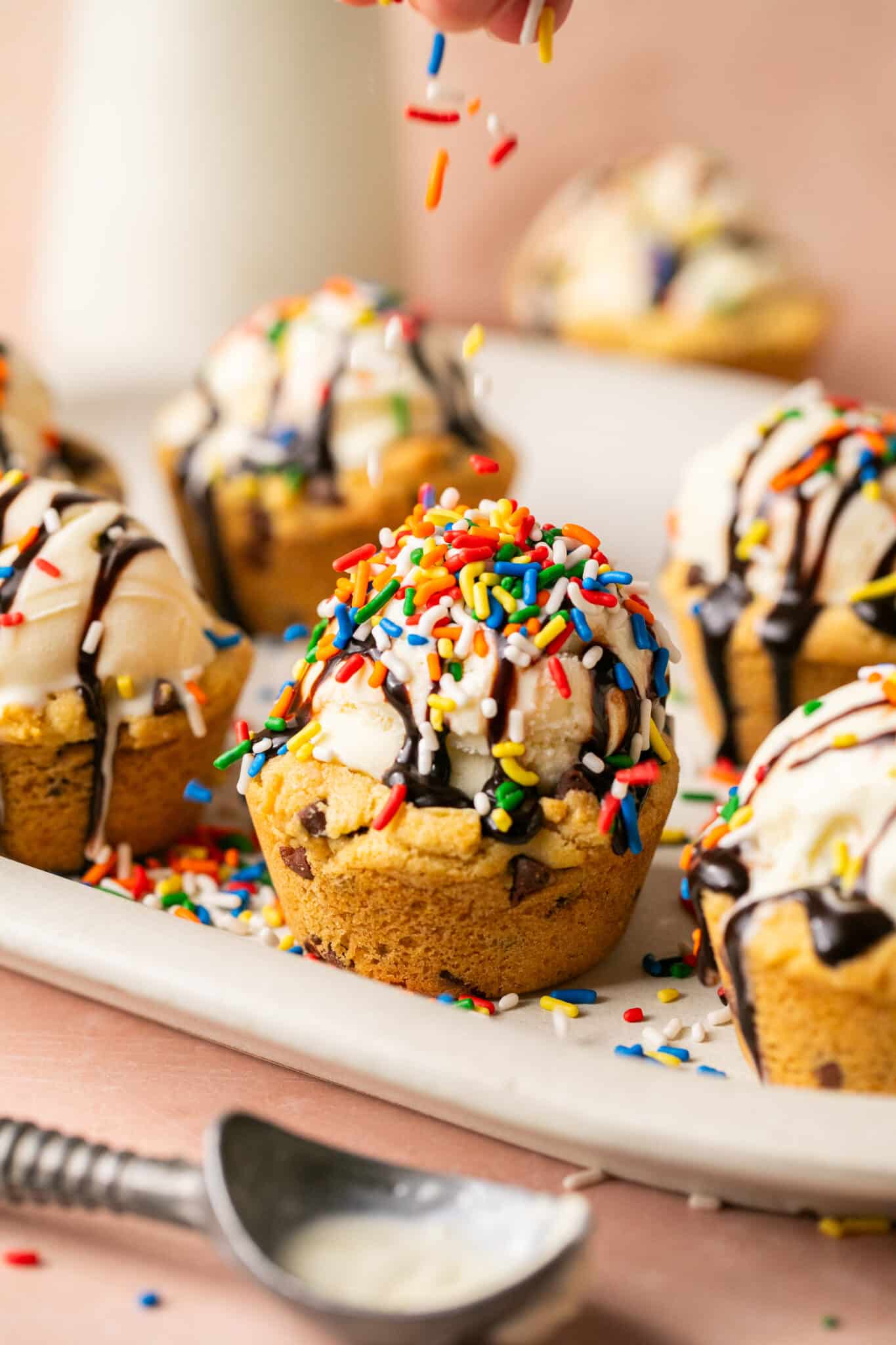 sprinkles on top of ice cream in a cookie cup. 