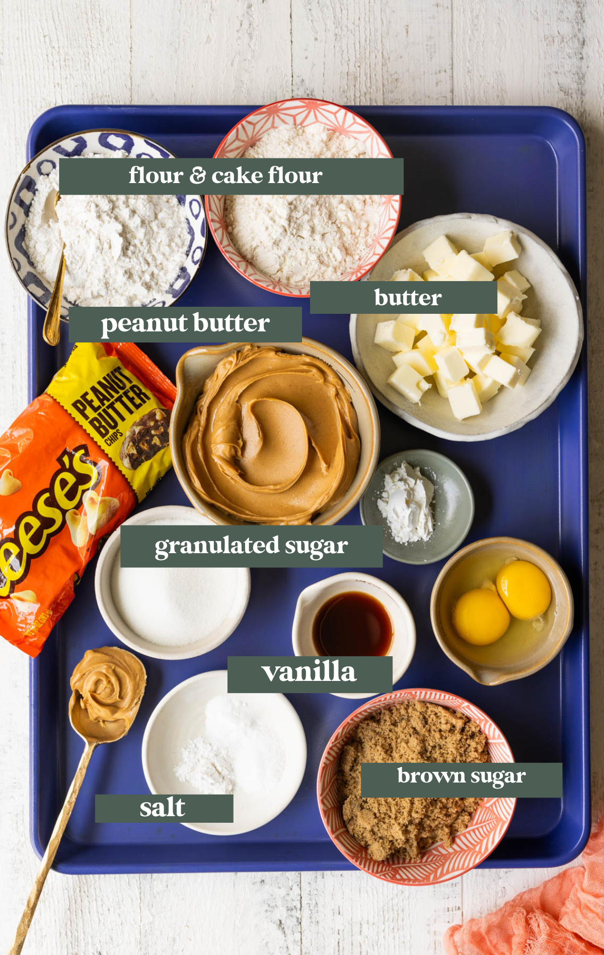 ingredients to make cookies on a blue baking sheet. 