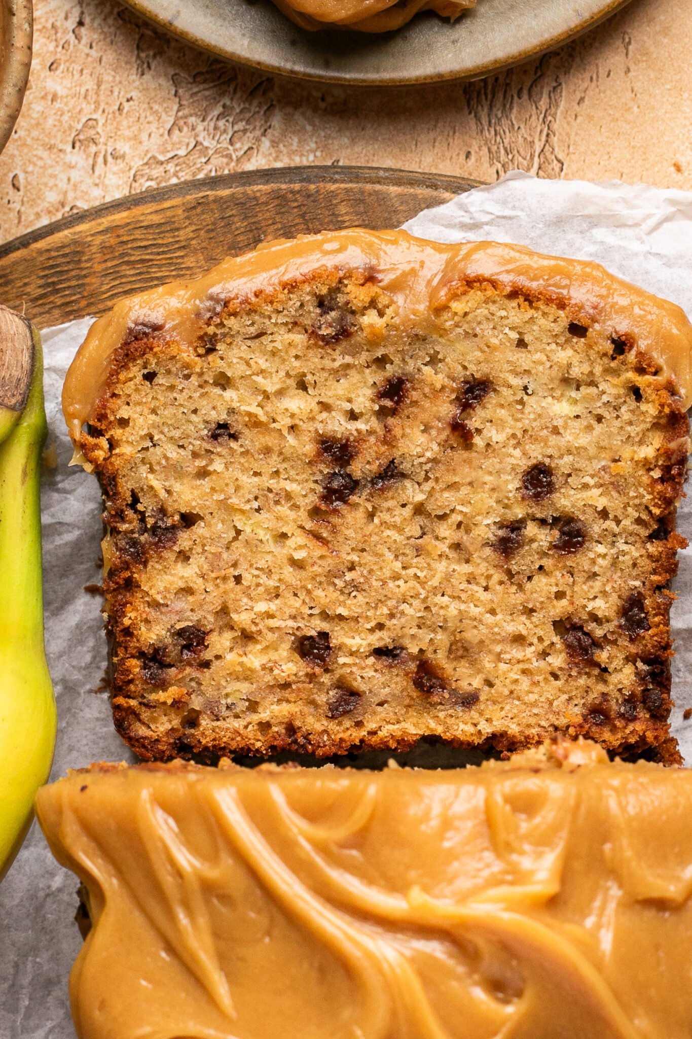 an up close image of peanut butter banana bread made with mini chocolate chips. 