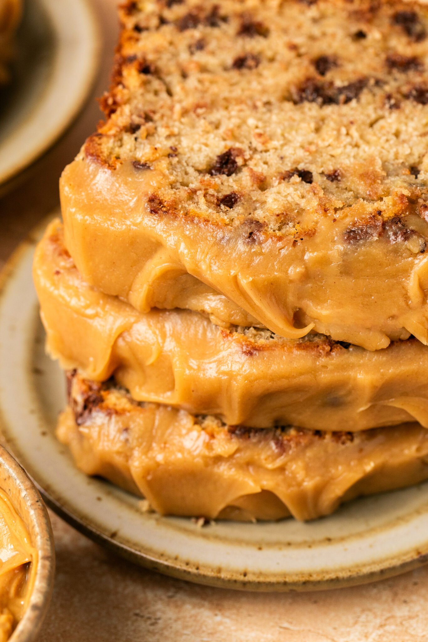 an up close image of banana bread with peanut butter frosting 