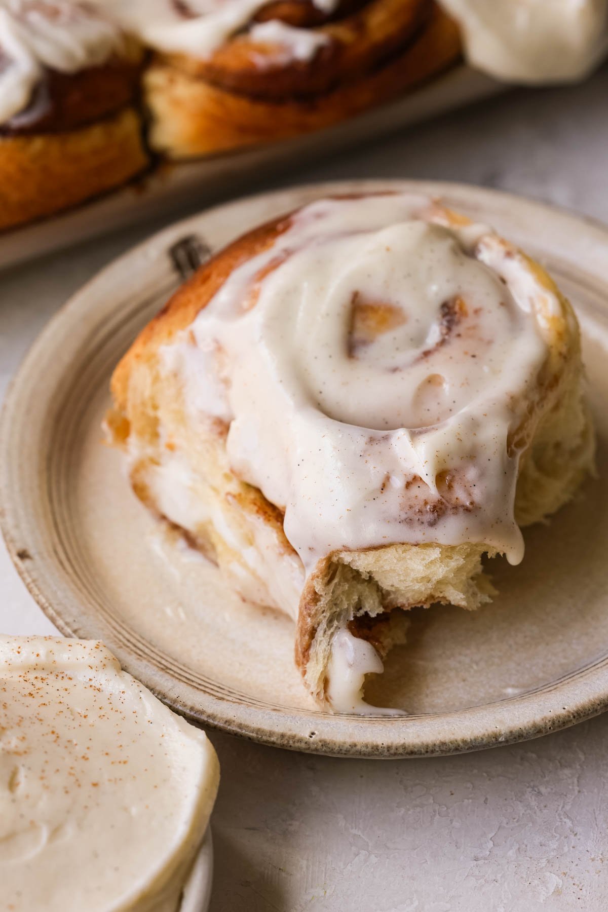 a gooey cinnamon roll on a plate. 