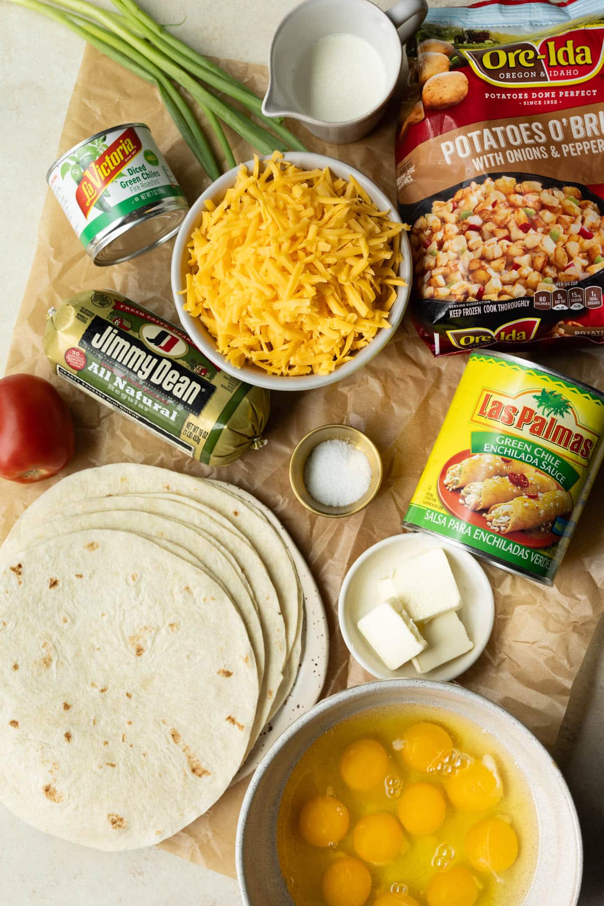 ingredients on parchment paper in glass bowls needed to make enchiladas. 