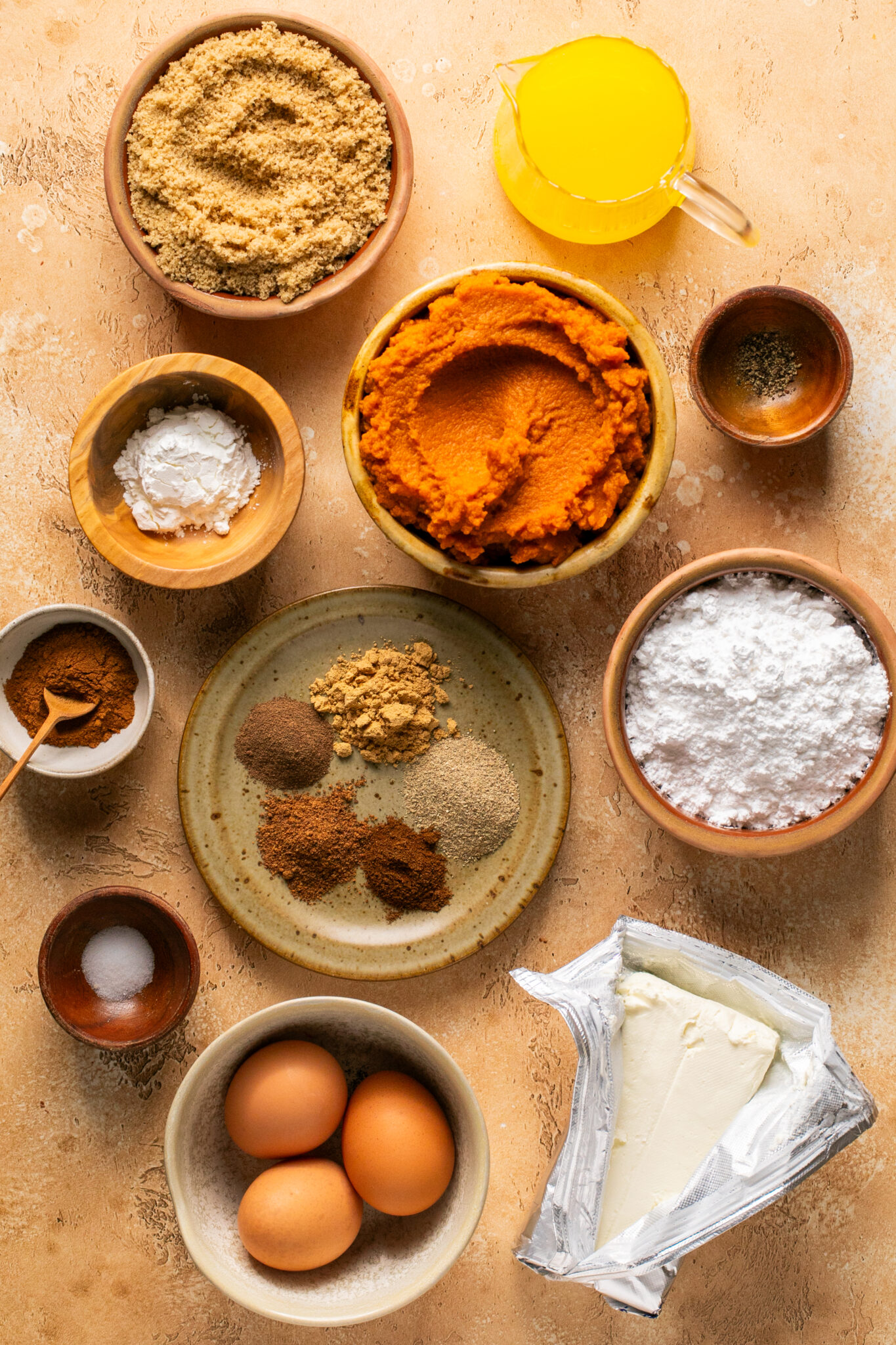 ingredients in small dishes needed to make pumpkin pie. 