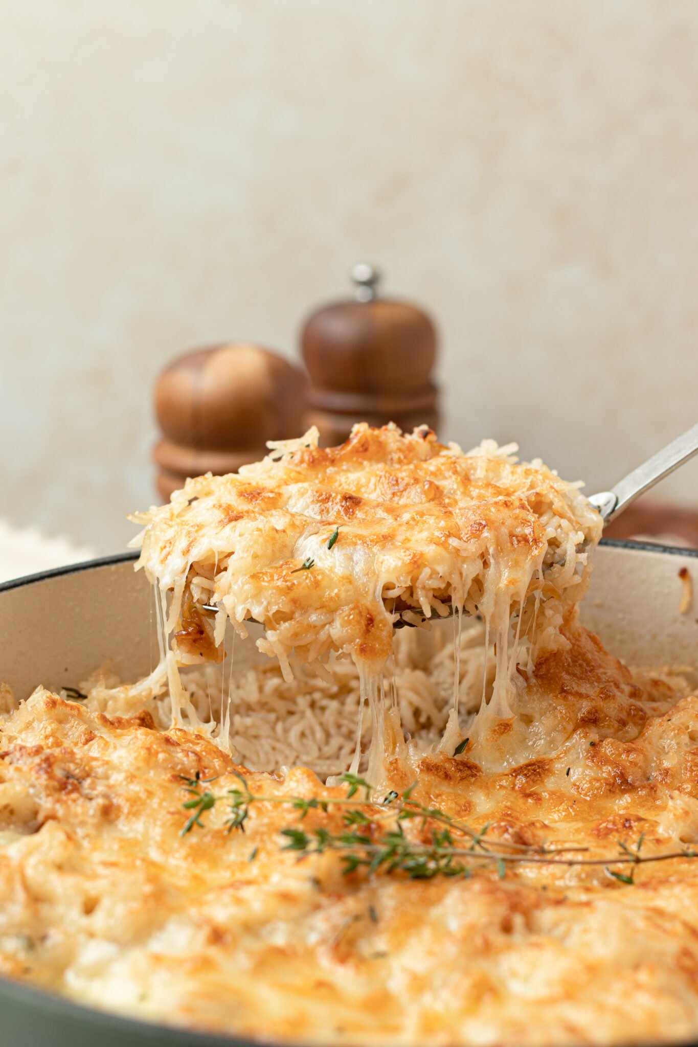 A spoon scooping up French onion pilaf. 