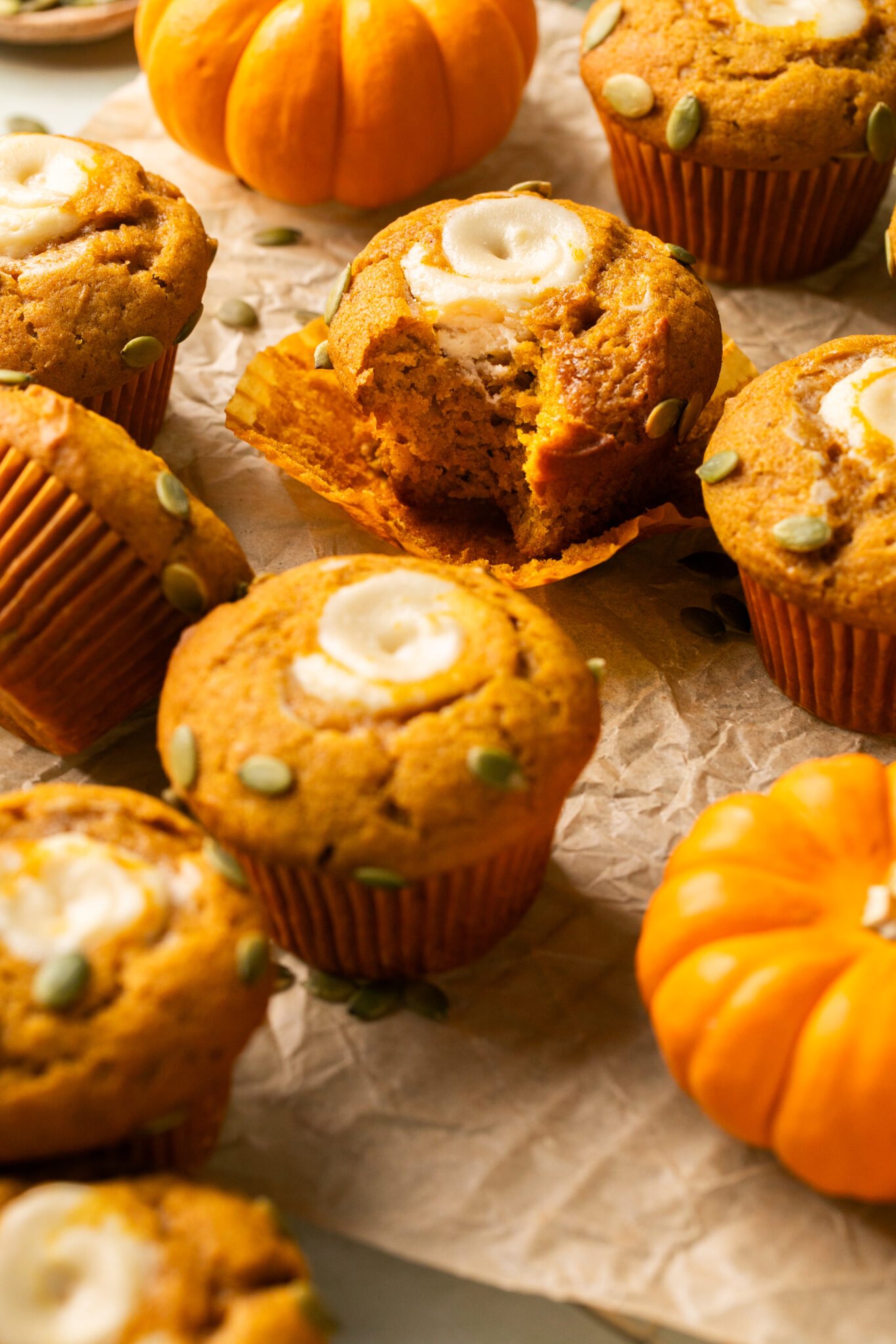 pumpkin cream cheese muffins on parchment paper. 