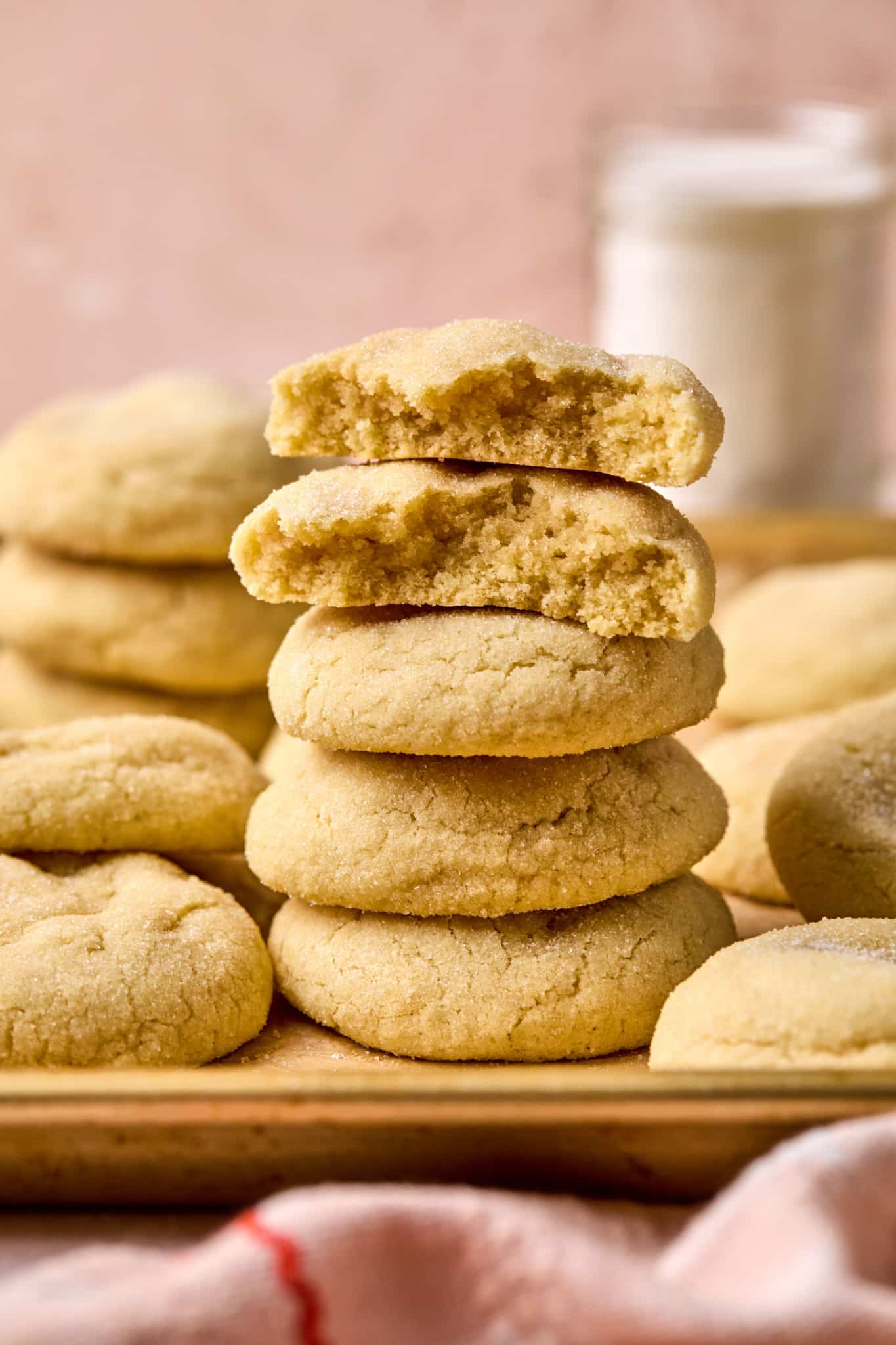 stack of several sugar cookies with top two cookies missing bites