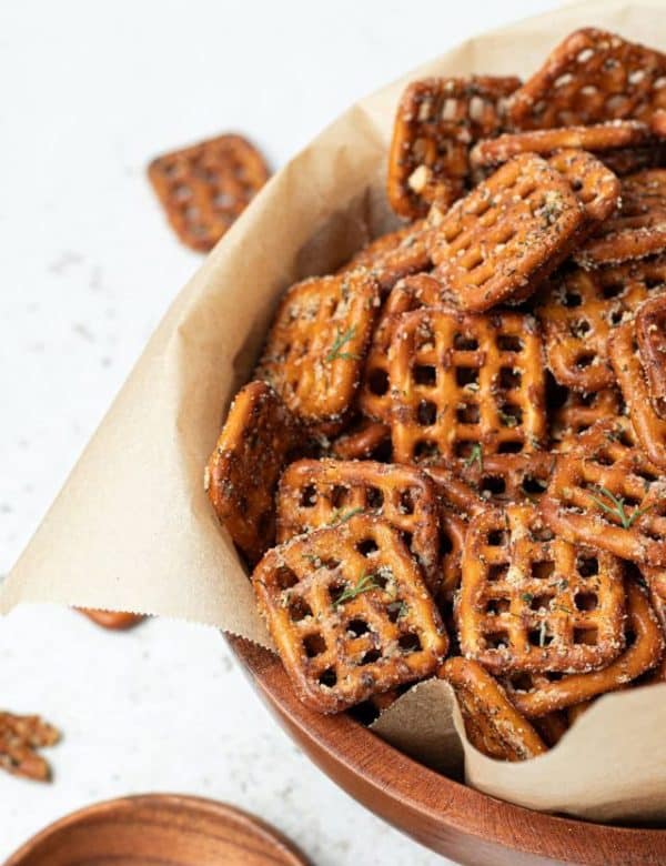 bowl lined with parchment paper and full of square pretzels