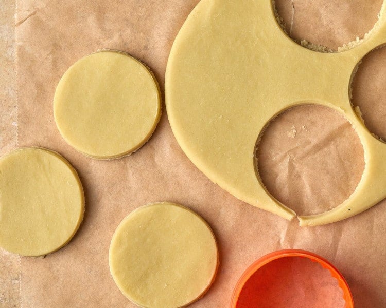 circles cut out of slab of cookie dough