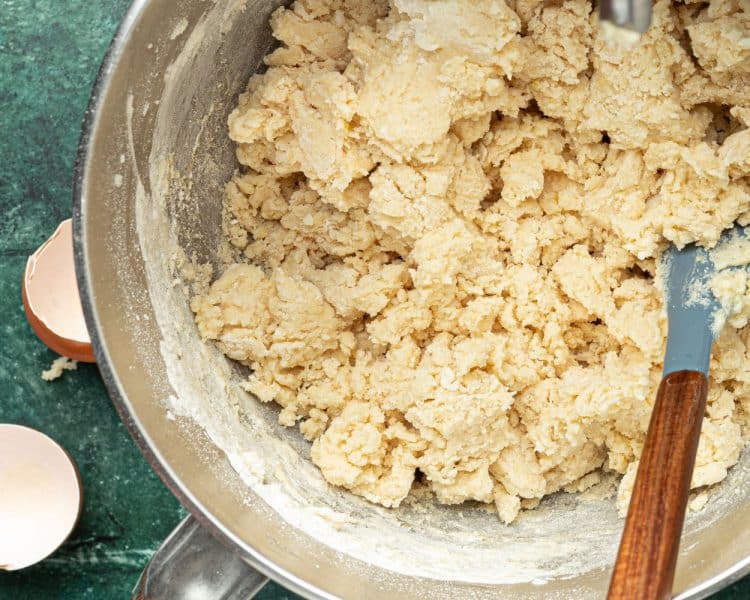 crumbly cookie dough in a silver bowl