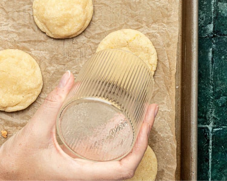 hand holding a clear up holding it over a cookie to maintain the circle shape