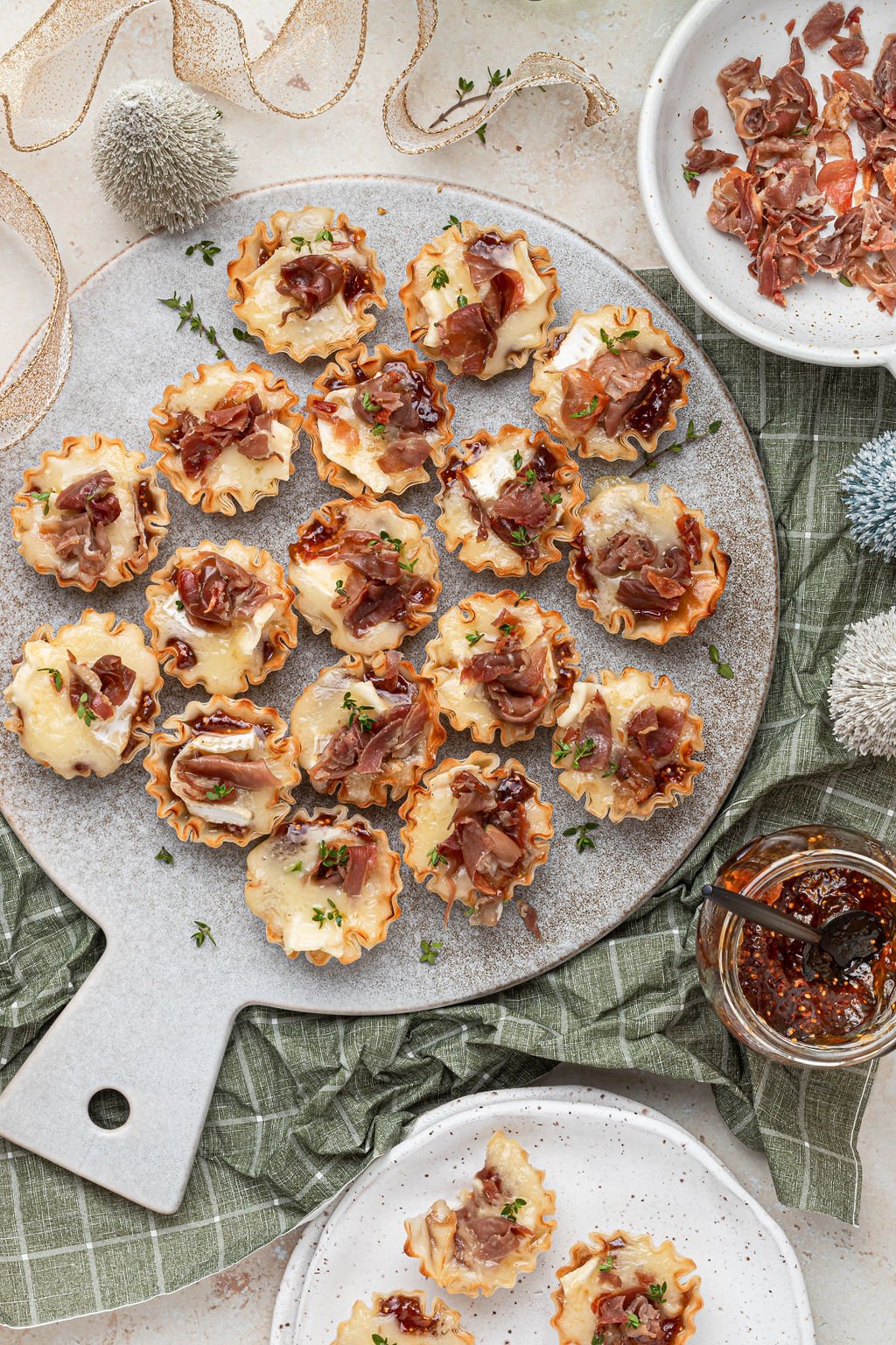 mini brie bites on a board garnished with fresh thyme, 