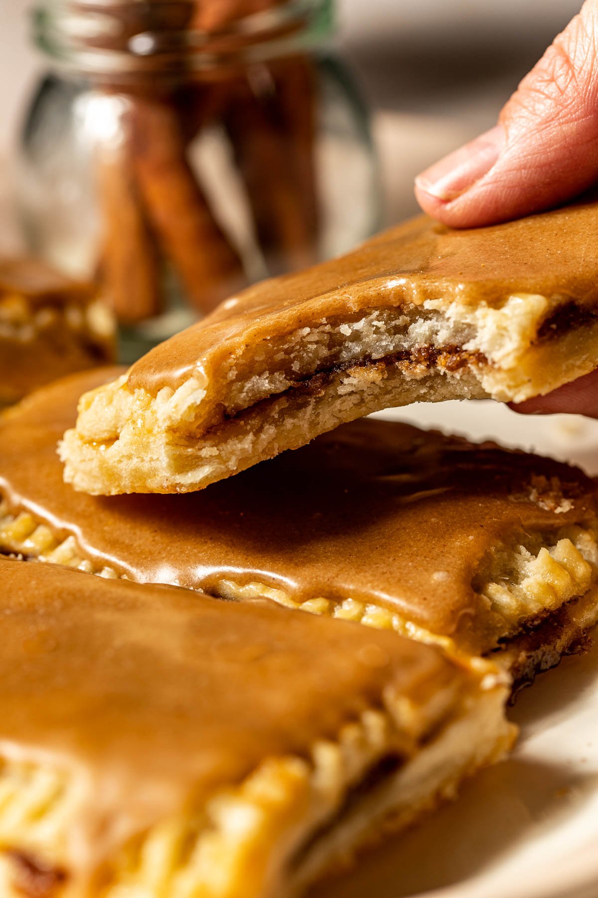 a hand holding a homemade brown sugar pop tart. 