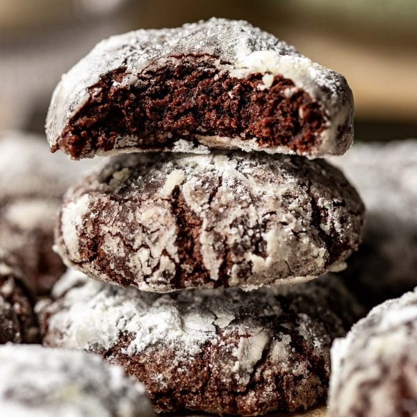 crinkle chocolate cookies stacked on top of each other.