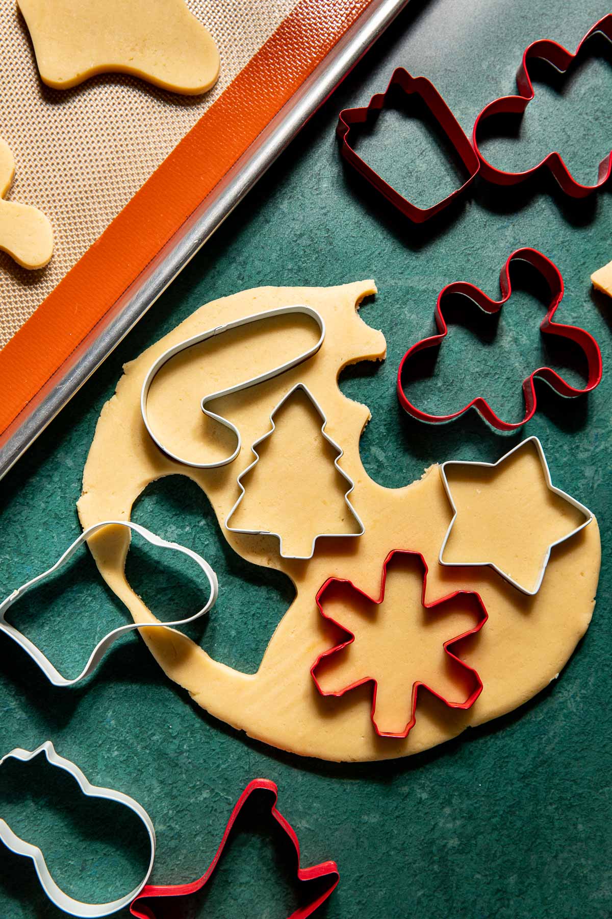 cookie cutters cutting out sugar cookies. 