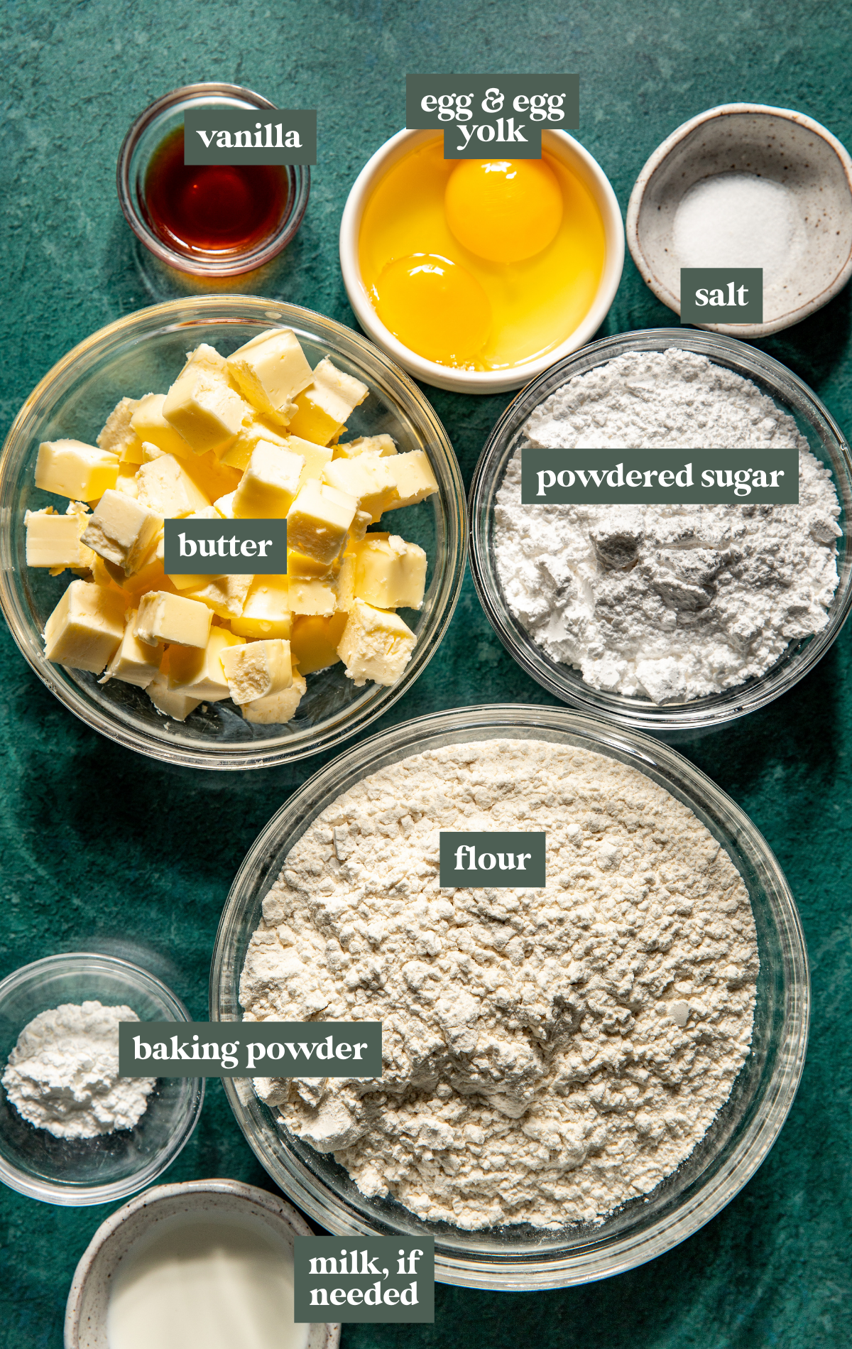 ingredients to make sugar cookies in glass bowls. 